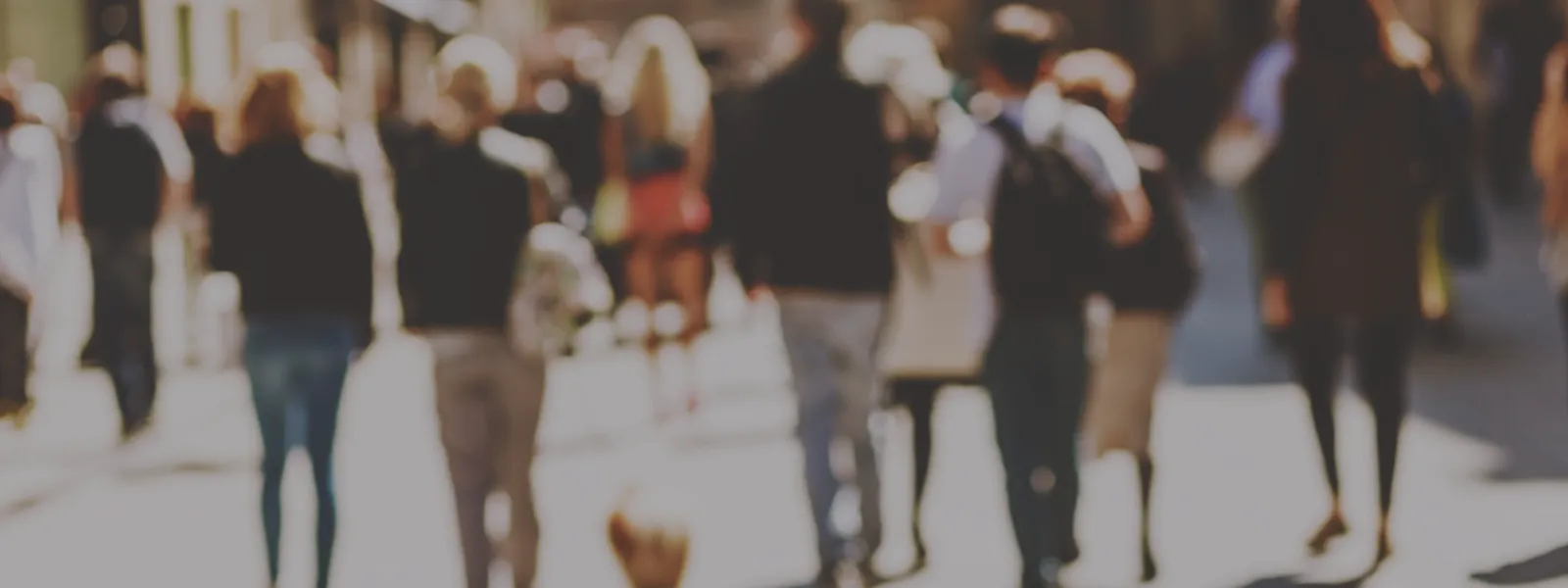 Blurred crowd walking down a city street